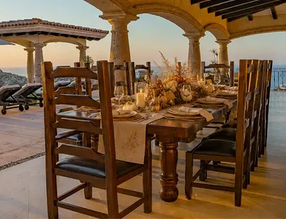 large wooden dining table with a view of the ocean