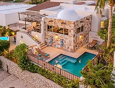 aerial view of a home in the evening with a pool
