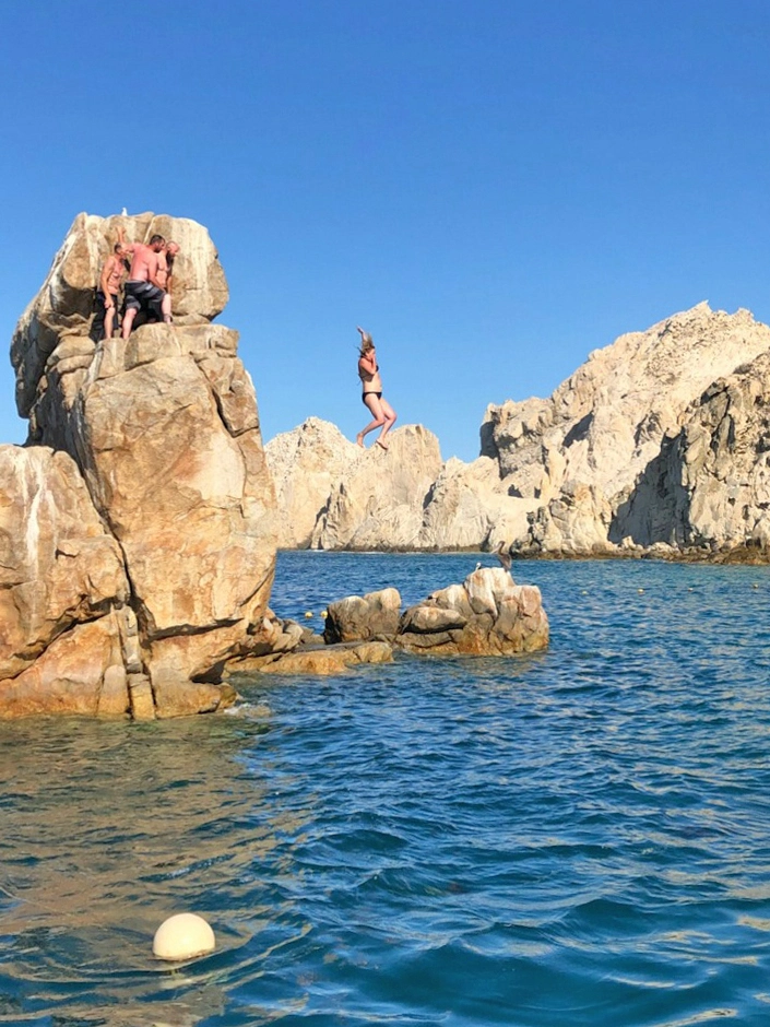 Jumping off of Pelican Rock near Land's End in Cabo San Lucas Mexico	