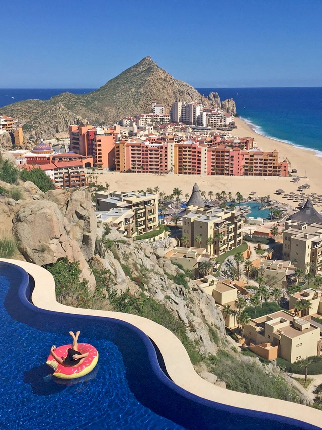 Relaxing in the pool at luxury Cabo San Lucas vacation rental Villa Bellissima	