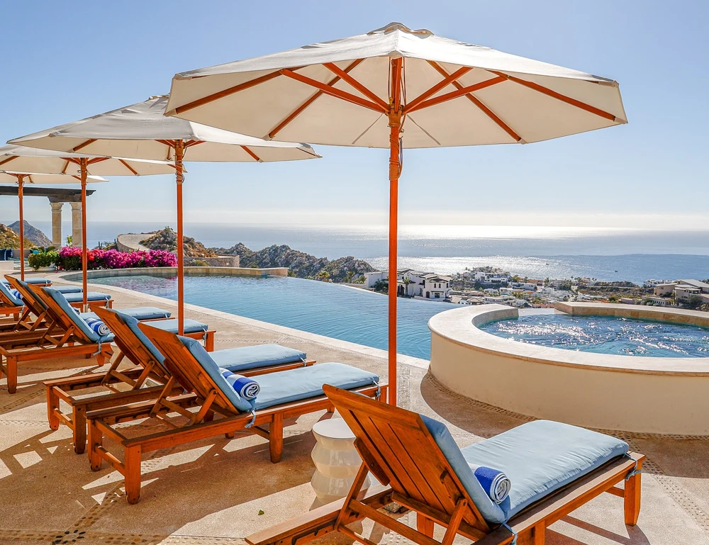 Cabo San Lucas luxury vacation rental Casa Stella pool terrace with jacuzzi and lounge chairs and sun umbrellas